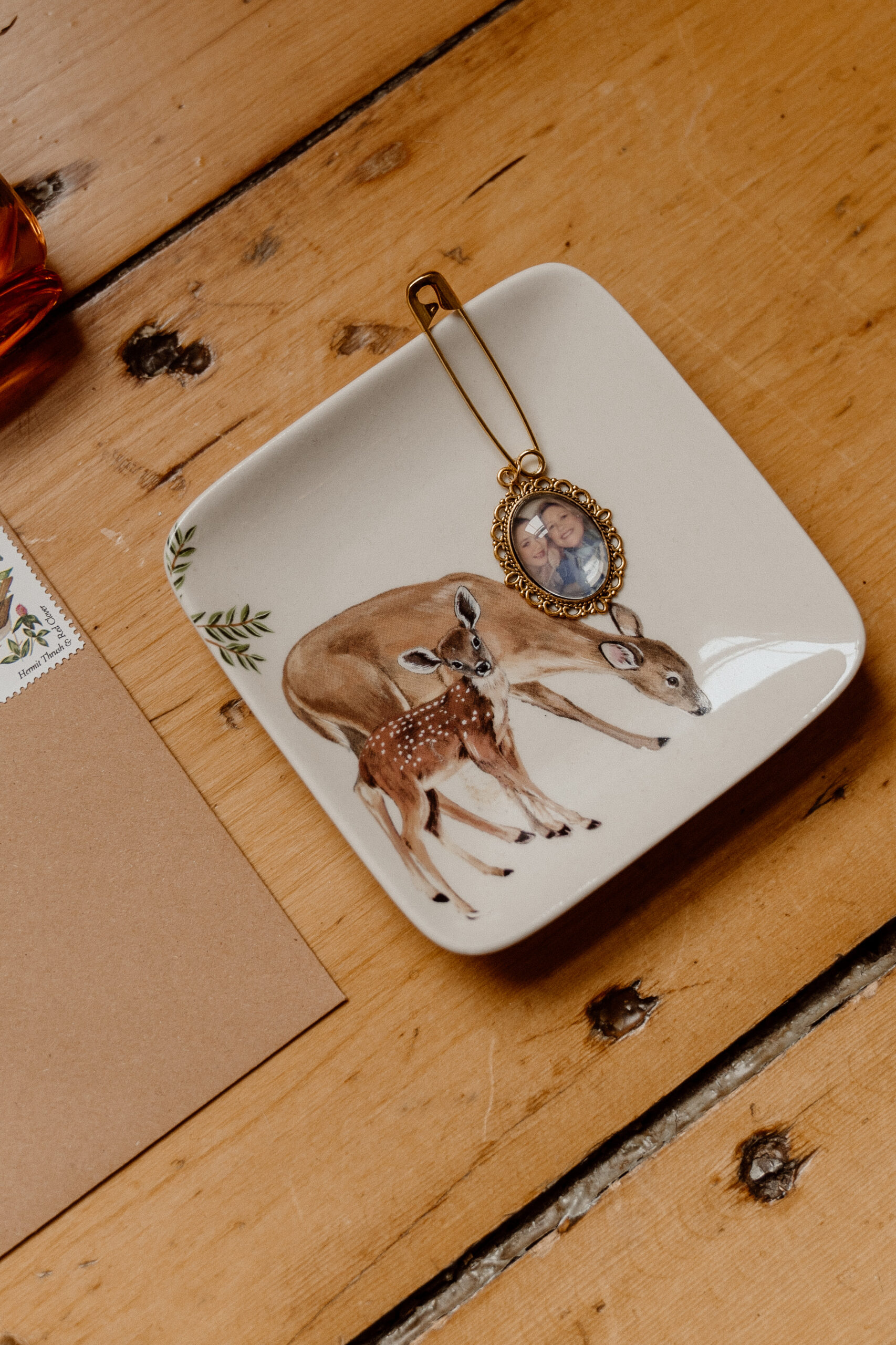 Mother daughter detail in this bridal flat lay. Mother deer & fawn with an image of the mother and the bride.