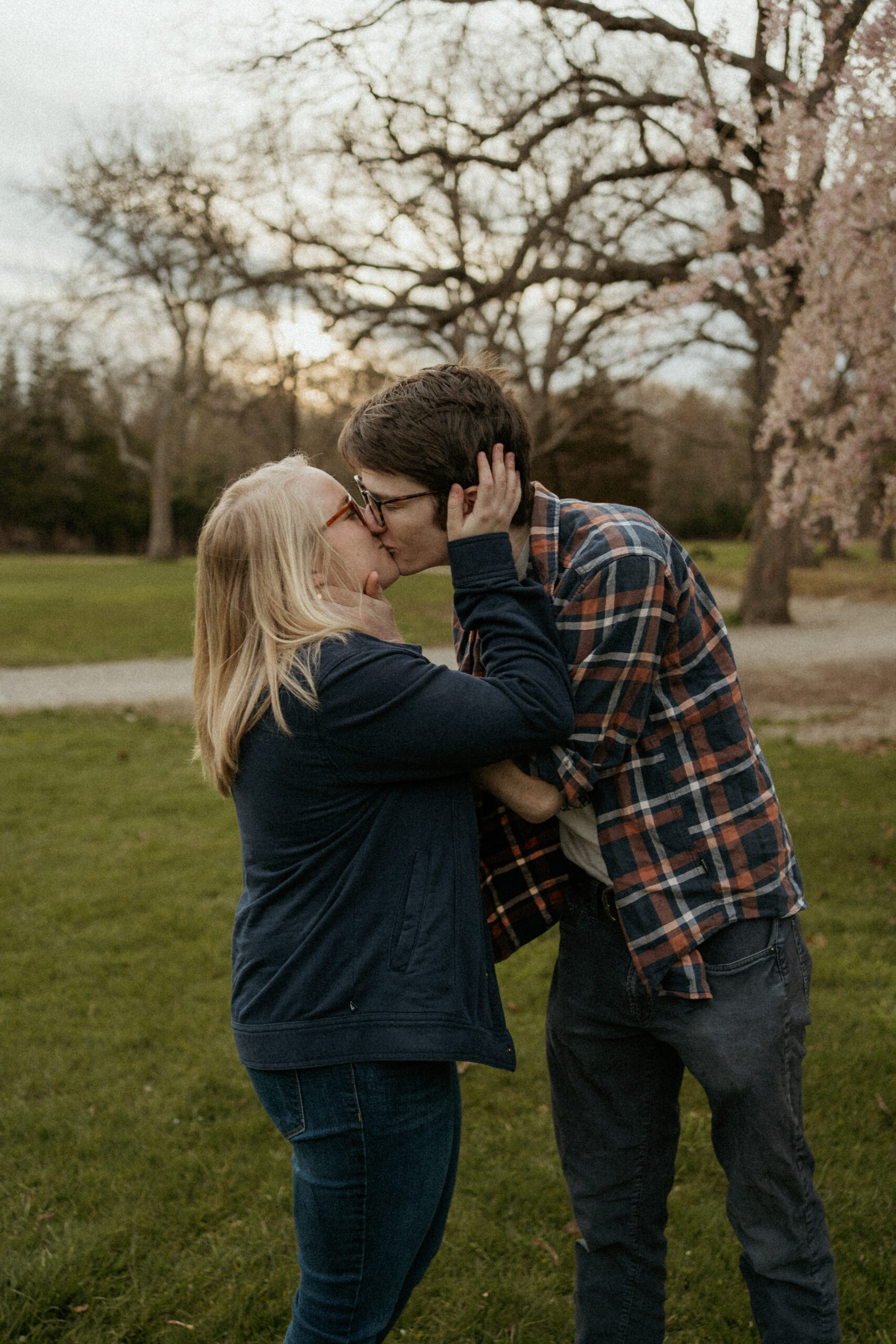 Engaged couple shares a tender, passionate kiss amidst the natural beauty of Borderland State Park in Easton, MA, capturing the depth of their love during their engagement photo session