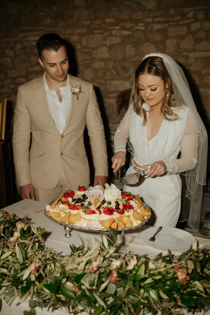 couple parttakes in the millefoglie italian tradition at their tuscan destination wedding