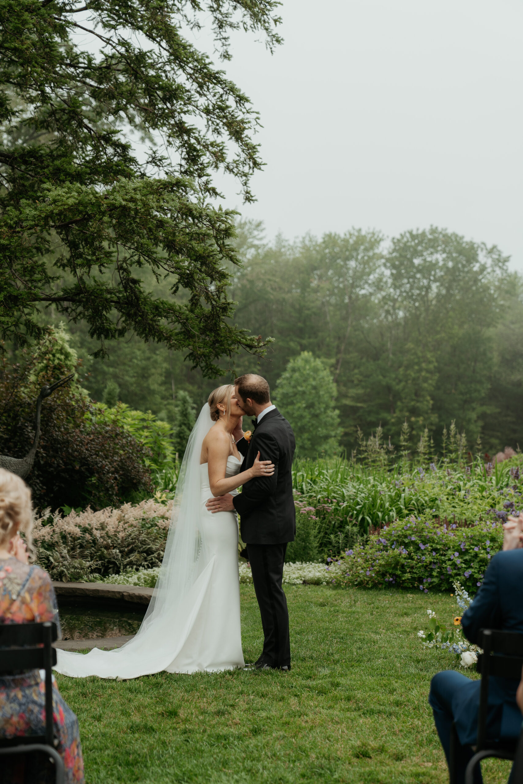 Couple having their first kiss at their New England Garden Party Ceremony