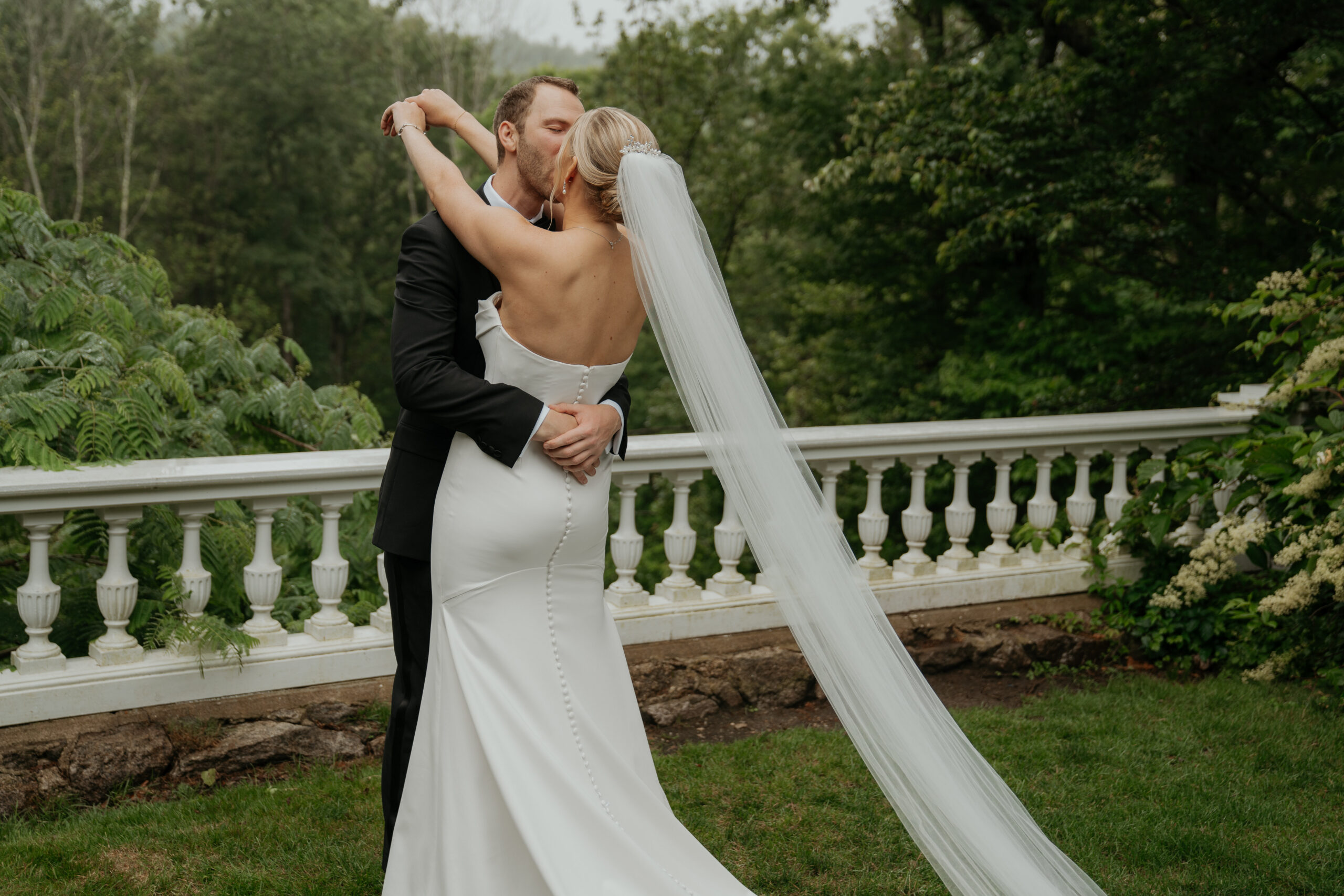 couple kissing after their first look at their wedding at Long Hill Beverly, MA