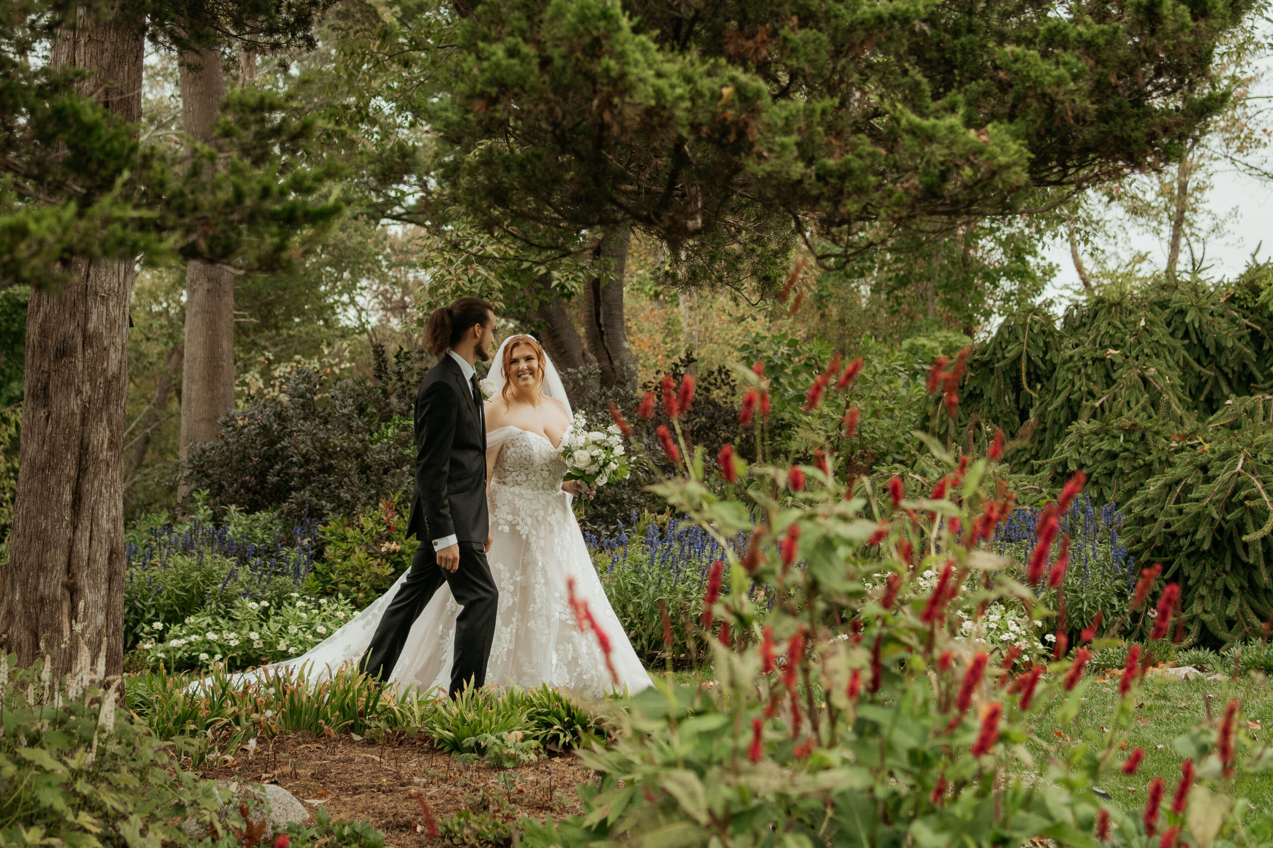 Bride and groom walk through the gardens of Long Hill after their wedding ceremony